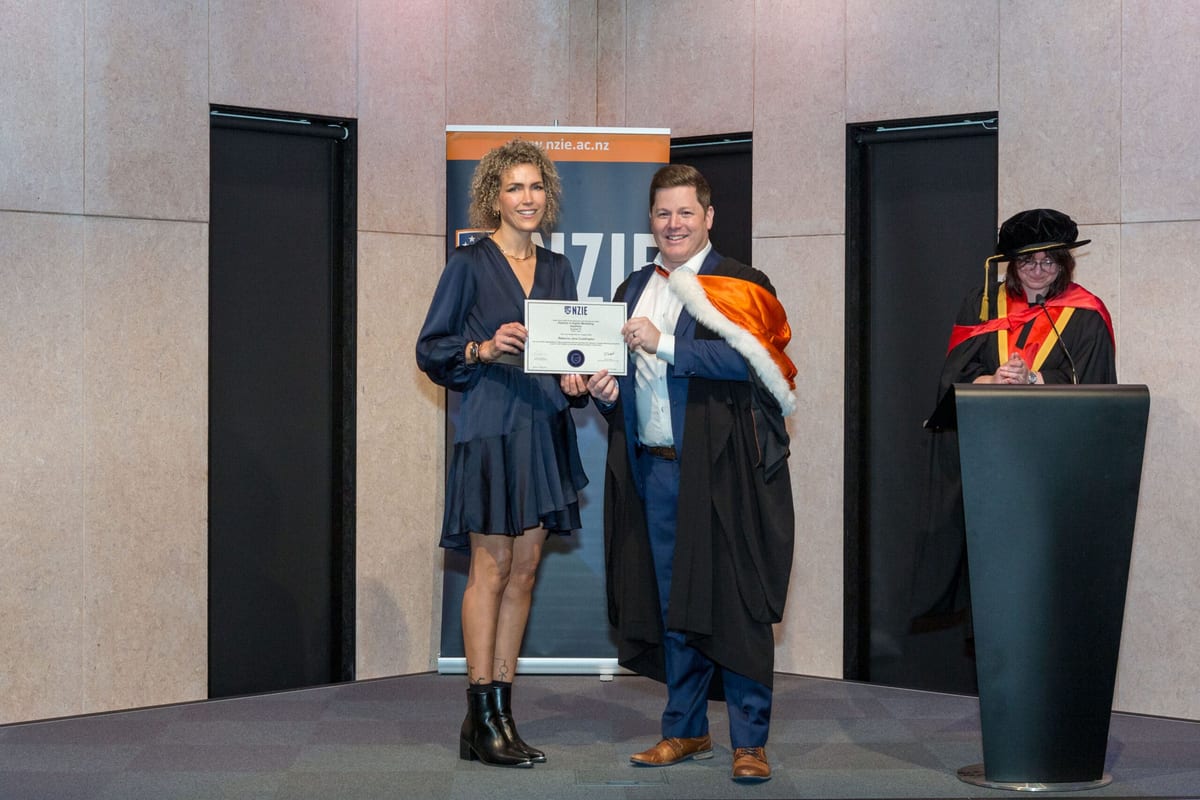 NZIE graduate receiving her diploma