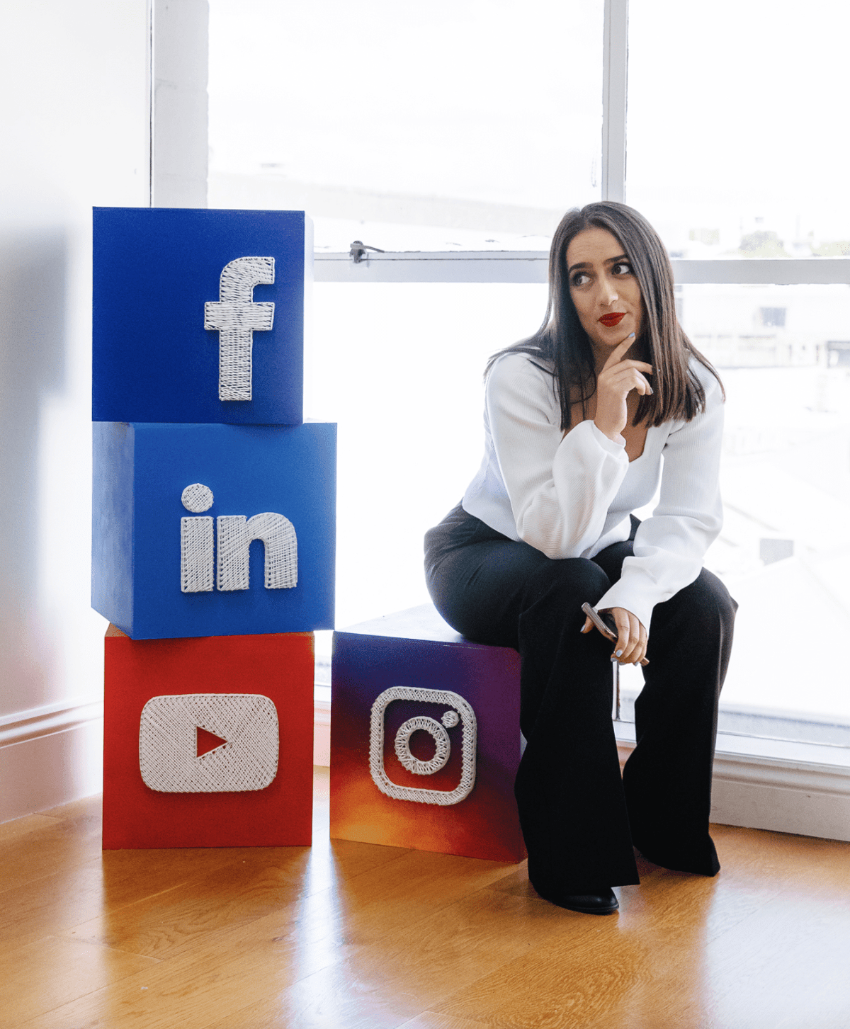 Social Media Marketing agecny owner posing with Facebook, LinkedIn, Youtube and Instagram icons